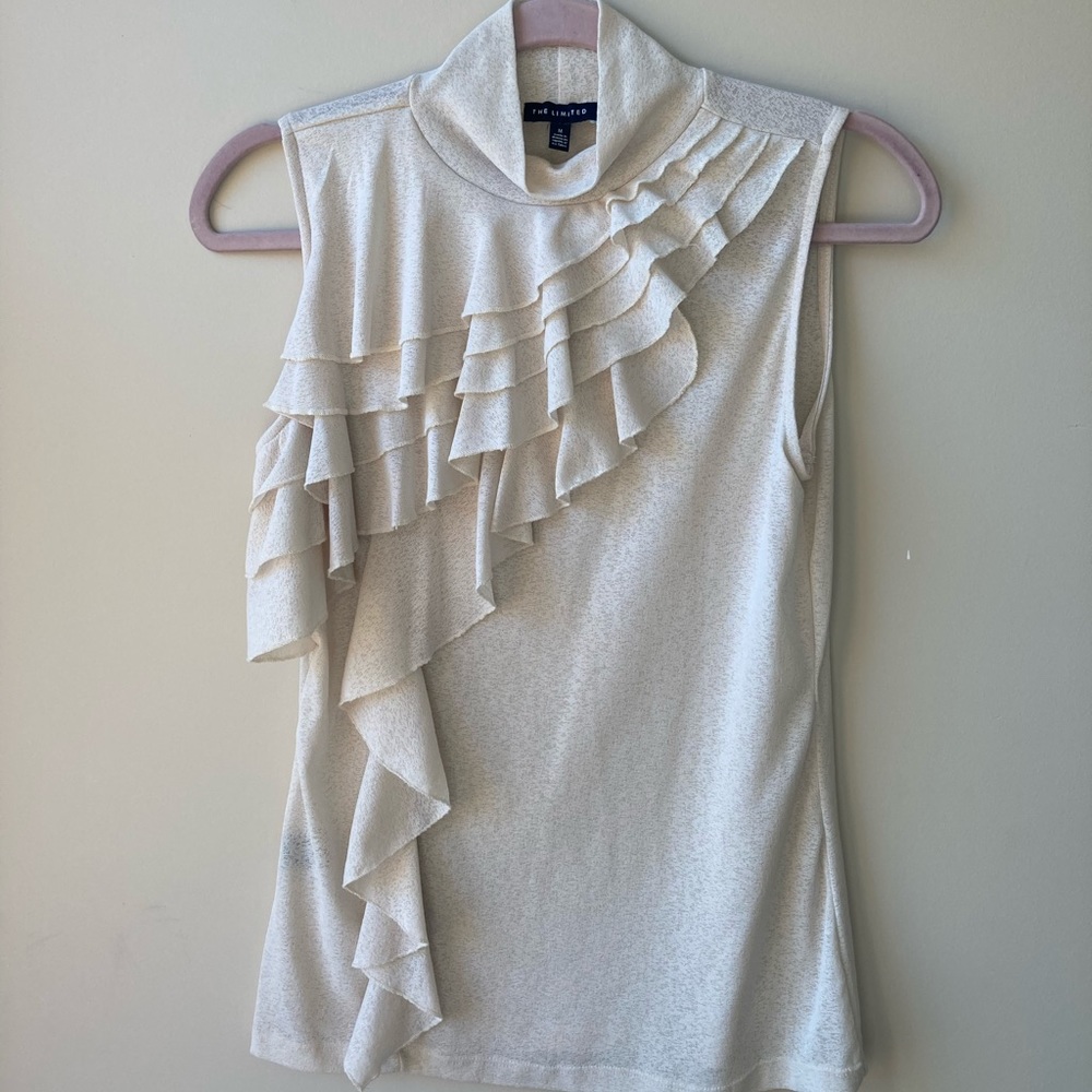 Cream ruffled blouse. Sleeveless mock turtleneck.